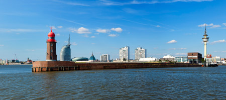 Panoramic view of Bremerhaven with historic lighthouse on the pier in foregroundのeditorial素材