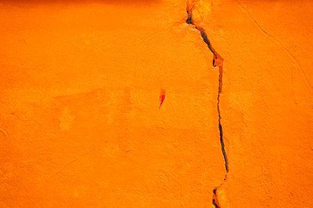 background of orange painted cracked wall