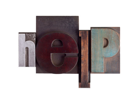Word help in vintage wooden letterpress type, scratched and stained, isolated on white background