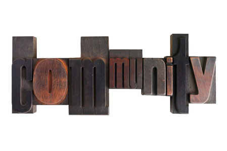 Word community in vintage wooden letterpress type, scratched and stained, isolated on white backgroundの写真素材
