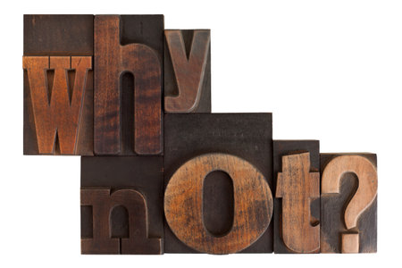 phrase why not? in vintage wooden letterpress type, scratched and stained, isolated on white backgroundの写真素材