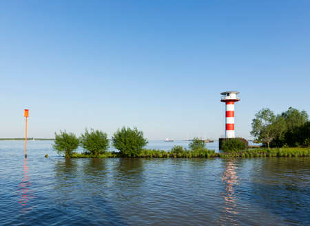 Lighthouse at Stadersand, mound of the Schwinge river into the Elbe riverの写真素材