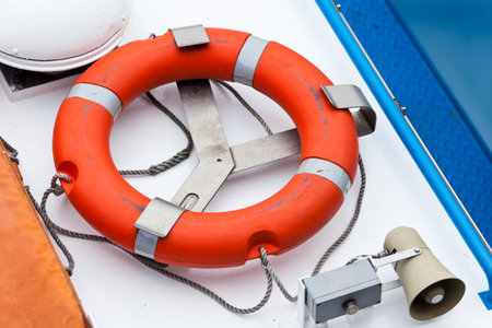 Orange lifebelt and horn on the deck of a ship