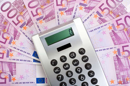 silver pocket calculator on 500 euro european currency notesの写真素材