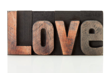 Love, word written with vintage letterpress printing blocks isolated on white backgroundの写真素材