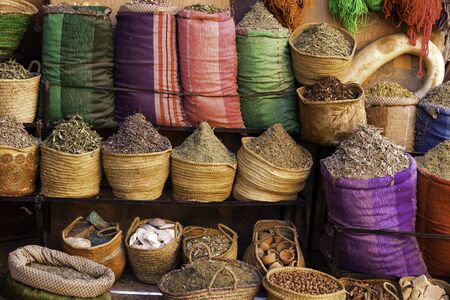 Variety of spices and herbs in bags at Marrakesh market standの写真素材