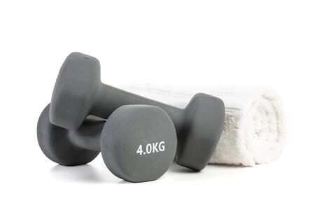 four kilogram dumbbells and  rolled towel isolated on white backgroundの写真素材