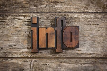 info, single word set with vintage letterpress printing blocks on rustic wooden backgroundの写真素材