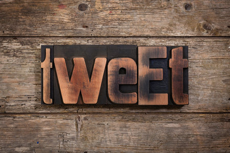 tweet, word set with antique letterpress type on rustic wooden backgroundの写真素材