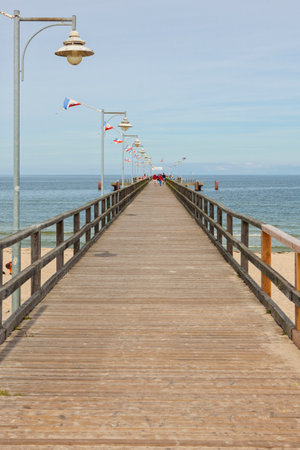 Goehren, Germany - September 22, 2016: The wooden pier at the Baltic Sea beach on a late summer day. The structure is 350 meters long and which reconstructed in 1993rdのeditorial素材