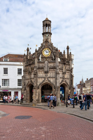 Chichester, Great Britain - May 17, 2014: Chichester Cross, a p erpendicular market cross in the centre of the city of Chichester, West Sussex. Several people sitting and standing inside and nearby, some passing by.のeditorial素材