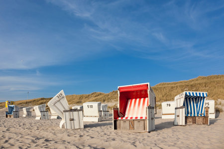 Typical beach chairs at Sylt, dunes in backgroundの写真素材