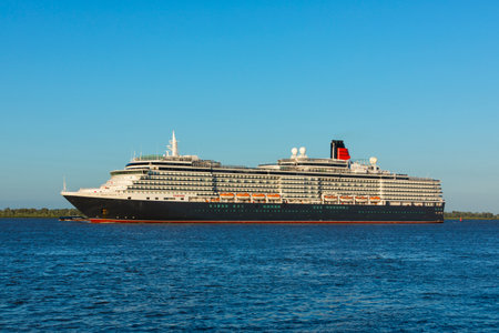 Stade, Germany - July 8, 2018: Cruise ship HMS Queen Victoria, operated by Cunard Lines, on Elbe river near Hamburg.のeditorial素材