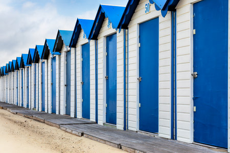 Row of wooden blue and white beach cabins at Boulogn-sur-Mer, Franceのeditorial素材
