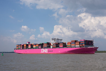 Stade, Germany - May 18, 2019: Ultra-large Container Ship ONE Columba on Elbe river heading to Hamburg. Passenger ship Schwingeflair in foreground.のeditorial素材