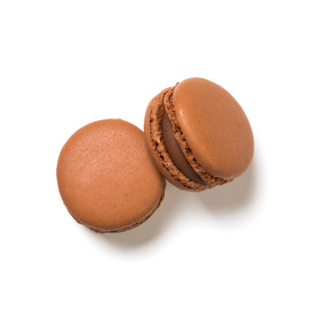 Chocolate flavor macarons top view isolated on white backgroundの写真素材