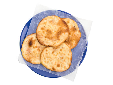 Spanish aniseed pastries Tortas de Aceite, on a blue plate, isolated on white background, top view