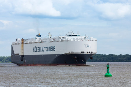 Stade, Germany - June15, 2021: Vehicles carrier HOEGH Seoul on Elbe river heading to Hamburg. The vessel owned by HÃ¶egh Autoliners sails under Norwegian flagのeditorial素材