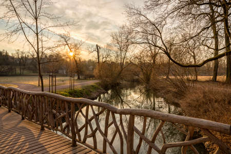 View from a wooden bridge crossing Ilm river into public park at Weimar, Thuringiaの写真素材