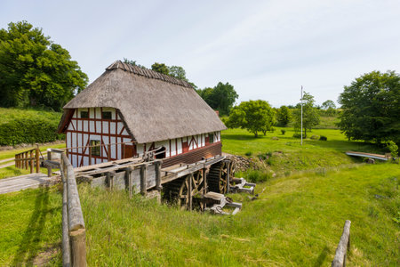 Historic half-timbered watermill with thatched roof at Vejstrup, Funen, Denmarkの写真素材