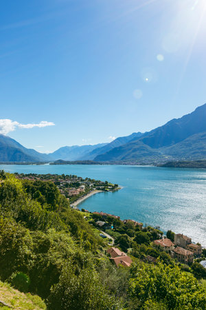 View from the green hills above Domaso, Italy, over Lake Como to the Valtellina valley. Lens flare on purpose.の写真素材