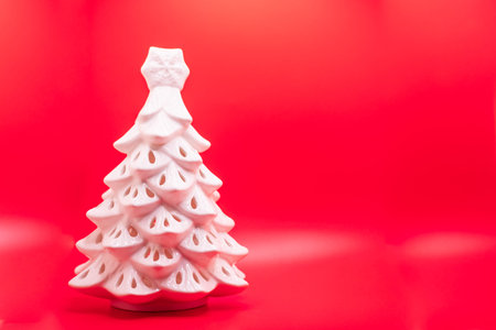 Christmas tree made of plasticine on a red background with copy spaceの写真素材