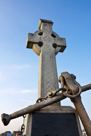 Irish sailors Celtic Cross monument at Howth harbor in Dublinの写真素材