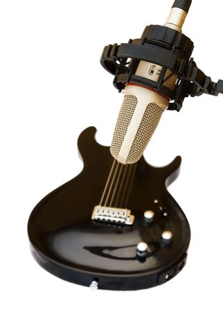 Studio recording microphone with black electric guitar isolated on white background.の写真素材