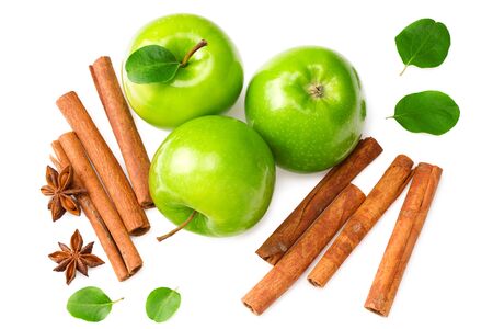 green apples with slices, green leaves, cinnamon and star anise isolated on white background. top viewの写真素材