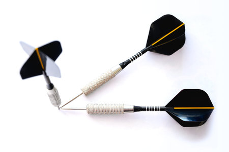 Three darts pointing the same target on an isolated white background. Straight to the aim of...