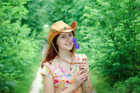 young pretty girl with bellflowersの写真素材