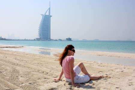young woman at the beach next to Burj Al Arab Hotel in Dubaiのeditorial素材