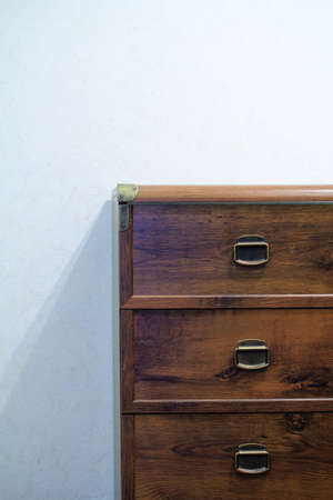 rustic chest of drawers made of oak wood with brass knobsの写真素材