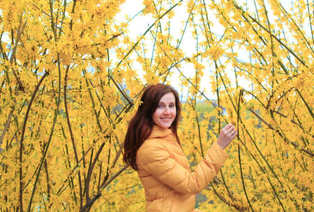 wooman and blooming tree, yellow colorsの写真素材