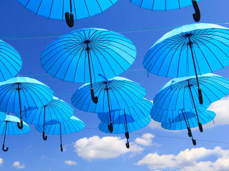 blue umbrellas in the skyの写真素材