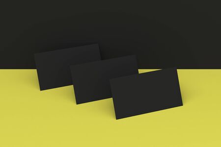 Black blank business cards mock-up on black and yellow background. Corporate stationery template. 3D rendering illustrationの写真素材