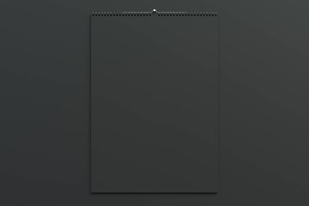 Black wall calendar mock-up on black background. Blank spiral calendar template. 3D rendering illustrationの写真素材