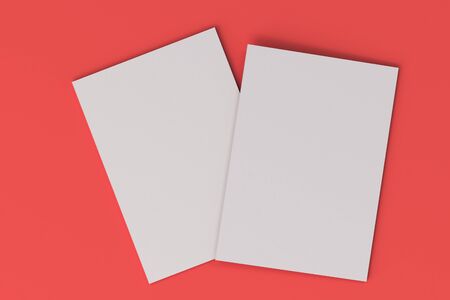 Two blank white closed brochure mock-up on red background. Magazine cover template. 3D rendering illustrationの写真素材