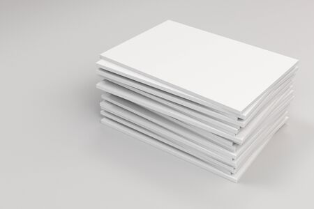 Stack of blank white closed brochure mock-up on white background. Magazine cover template. 3D rendering illustrationの写真素材