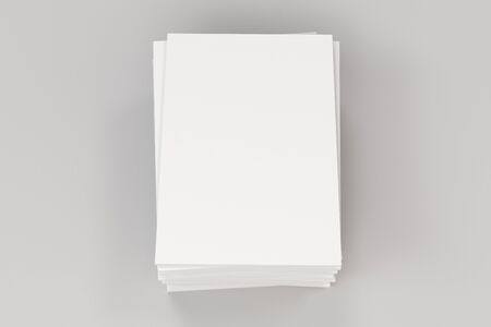 Stack of blank white closed brochure mock-up on white background. Magazine cover template. 3D rendering illustrationの写真素材