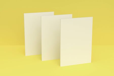 Three blank white closed brochure mock-up on yellow background. Magazine cover template. 3D rendering illustrationの写真素材