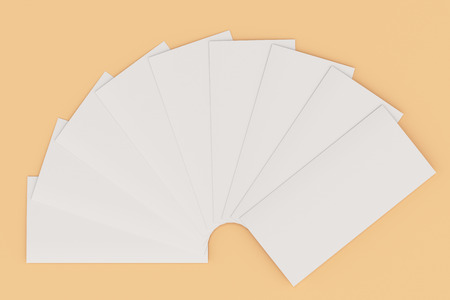 Blank white three fold brochure mockup on orange background. Leaflet or booklet template. 3D rendering illustrationの写真素材