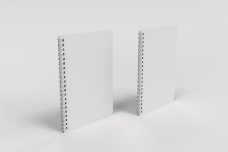 Two blank notebooks with white cover and metal spiral bound on white background. Business or education mockup. 3D rendering illustrationの写真素材
