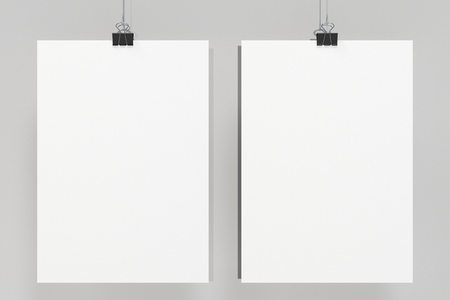 Two blank white posters with binder clip mockup on white background. Poster or paper sheet template. 3D rendering illustrationの写真素材