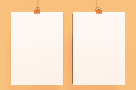 Two blank white posters with binder clip mockup on orange background. Poster or paper sheet template. 3D rendering illustrationの写真素材