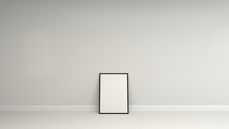 Blank white poster in black frame standing on the floor near the wall. Picture or photo mockup. 3D render illustrationの写真素材