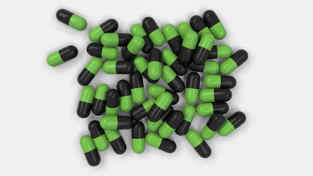 Pile of black and green medicine capsules on white background. Medical, healthcare or pharmacy concept. 3D rendering illustrationの写真素材