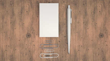 Black business cards, paper clips and automatic ballpoint pen on wooden table. Blank paper mockup. 3D rendering illustration.の写真素材