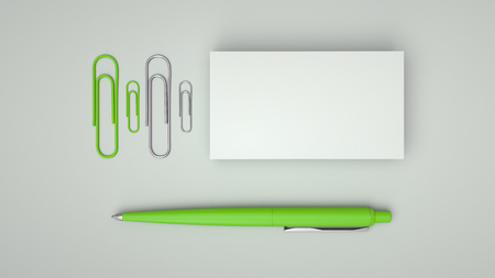 White business cards, paper clips and green automatic ballpoint pen isolated on white background. Blank paper mockup. 3D rendering illustration.の写真素材