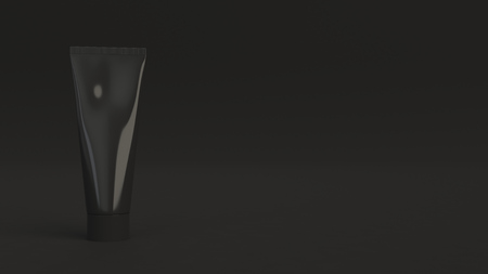 Blank black tube of toothpaste, cream or gel standing on black background. Branding mockup. 3D rendering illustrationの写真素材